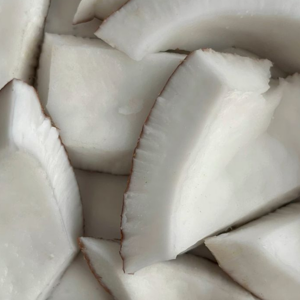 Sliced up coconut flesh and shell